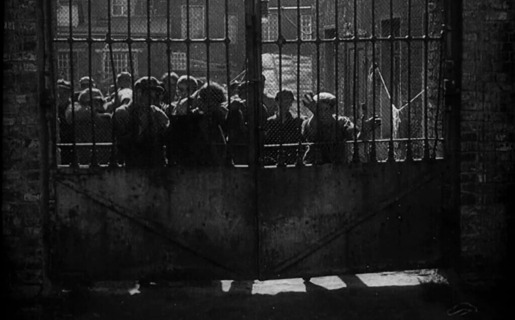 Strike (1925) workers behind gate