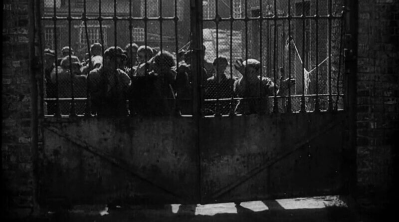 Strike (1925) workers behind gate
