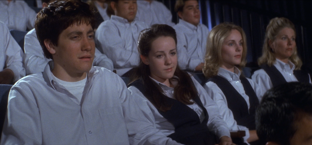 Donnie and Gretchen sit together during a school assembly in Donnie Darko.