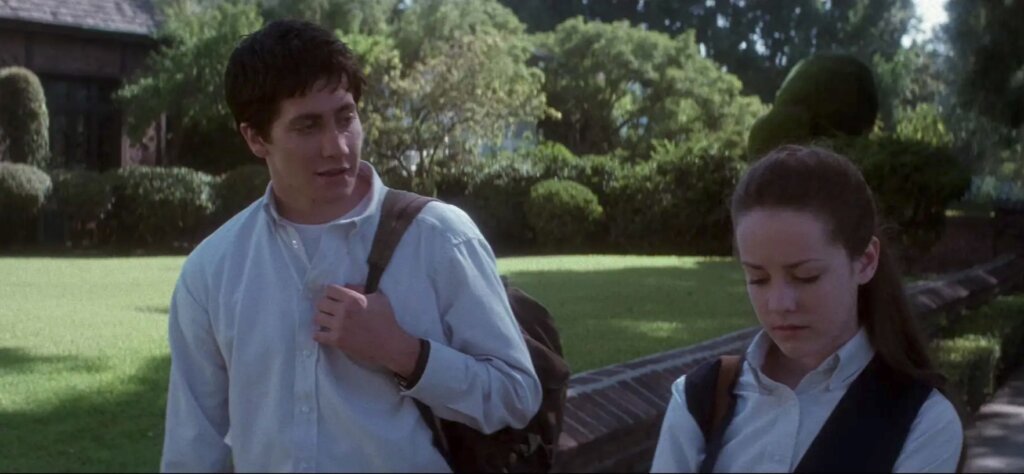 Donnie and Gretchen walk beside a garden wall in Donnie Darko.