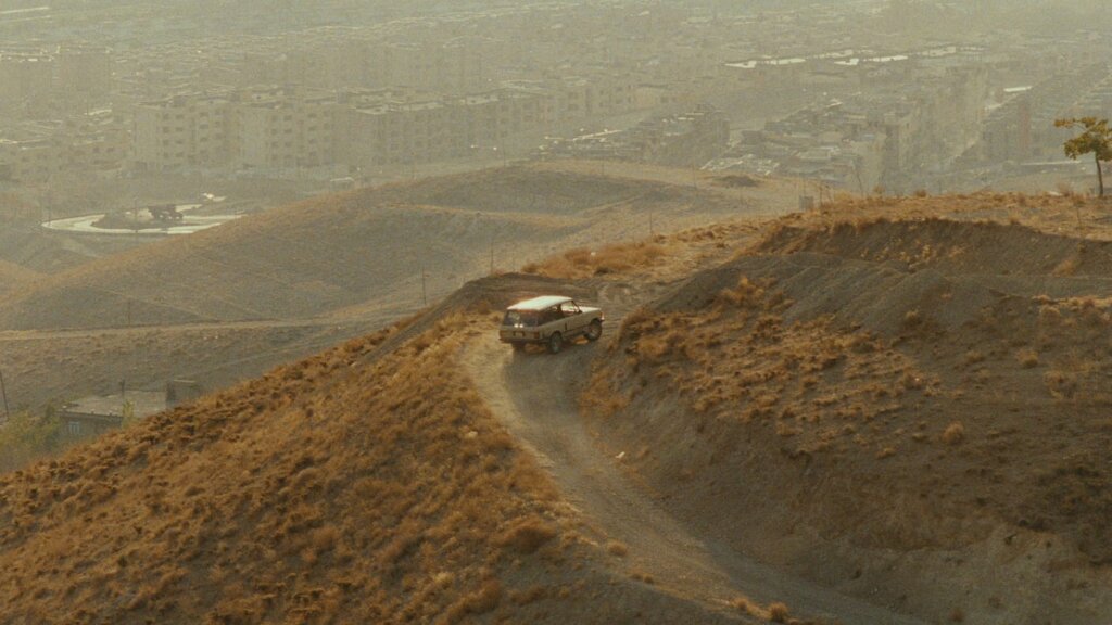 Mr. Badii’s car follows a winding road through the hills outside Tehran in Taste of Cherry