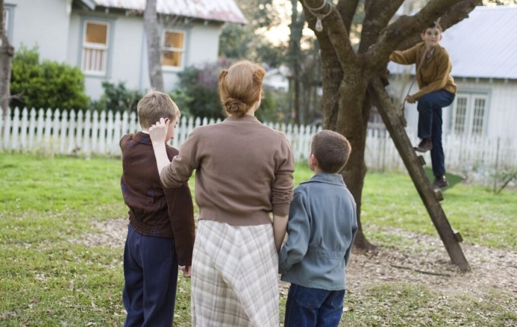 Mrs. O’Brien and her sons gather around a tree in The Tree of Life