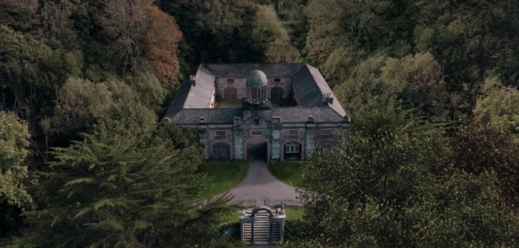 The isolated stone house surrounded by dense woodland in Oddity