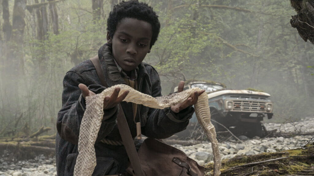 Nolan holds the family’s safety rope beside an abandoned car in Never Let Go.
