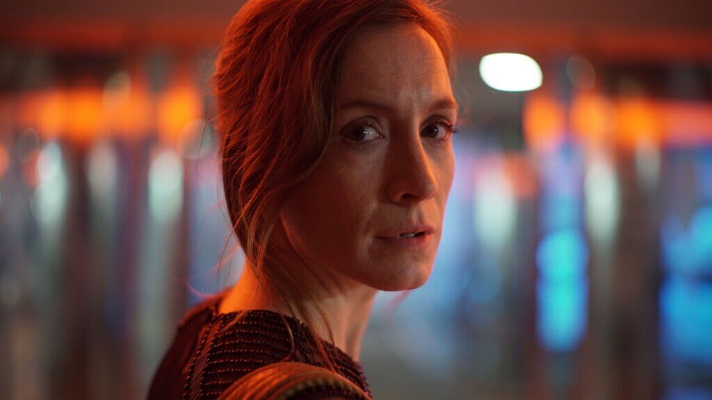 Mimaroben turns beneath red and blue spacecraft lights in Aniara (2018)