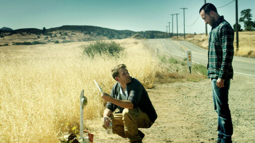 Justin and Aaron pause beside a remote California road in The Endless (2017)