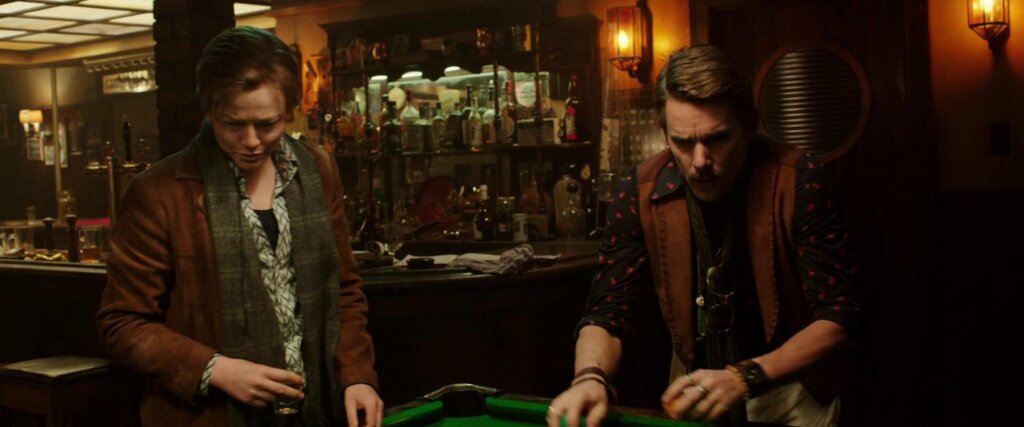John and the temporal agent stand over a pool table during their barroom encounter in Predestination.