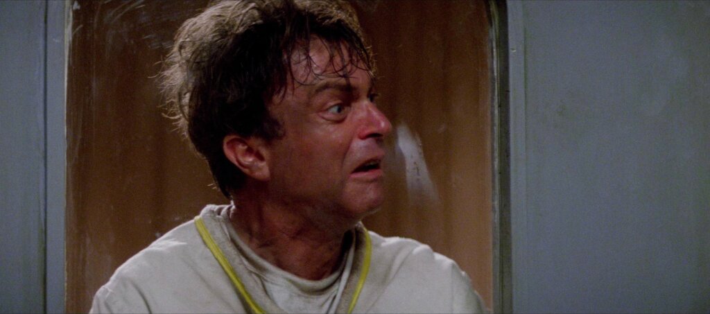 John Trent looks through his psychiatric cell door in In the Mouth of Madness (1994)