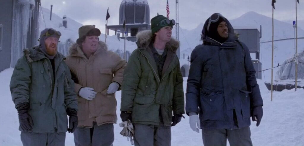 Outpost 31 crew members scan the Antarctic base in The Thing (1982)