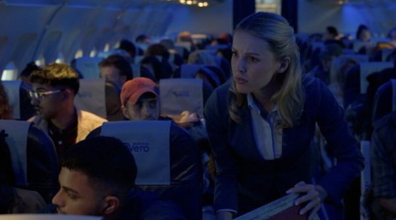 A flight attendant speaks to concerned passengers aboard Flight 298 in Black Box (2026).