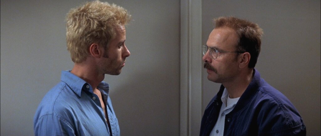 Leonard Shelby confronts Teddy face-to-face during a tense encounter in Memento (2000).