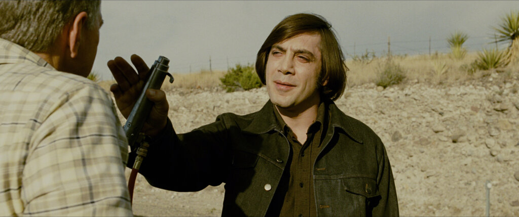 No_Country_for_Old_Men_01_Featured_Chigurh_Roadside.jpg Anton Chigurh confronts a driver on a sunlit Texas roadside.