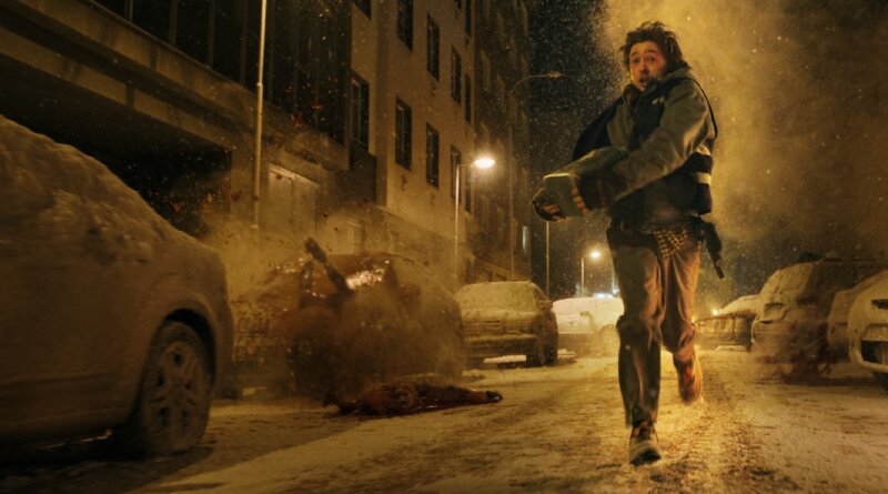Bryan runs through a snow-covered Raccoon City street as debris erupts behind him in Resident Evil (2026).