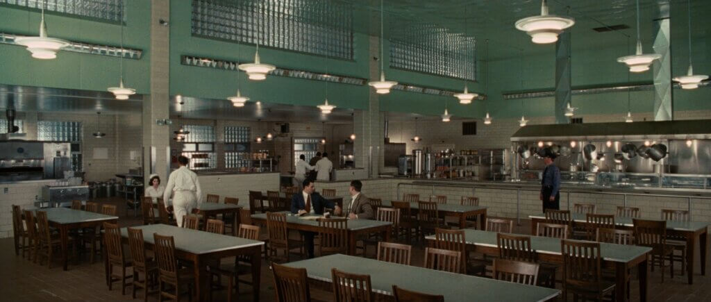 Teddy Daniels and Chuck Aule sit together in the cafeteria at Ashecliffe Hospital.
