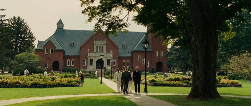 Andrew Laeddis walks with Dr. Cawley and Dr. Sheehan across the grounds of Ashecliffe Hospital.
