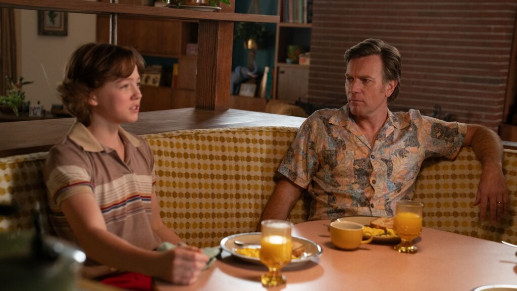 Greg and Brian sit across from one another during a tense family breakfast in The End of Oak Street.