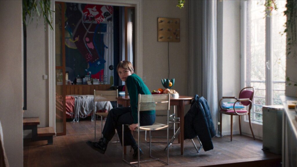 Elif sits alone inside a sunlit apartment in Hysteria (2025).