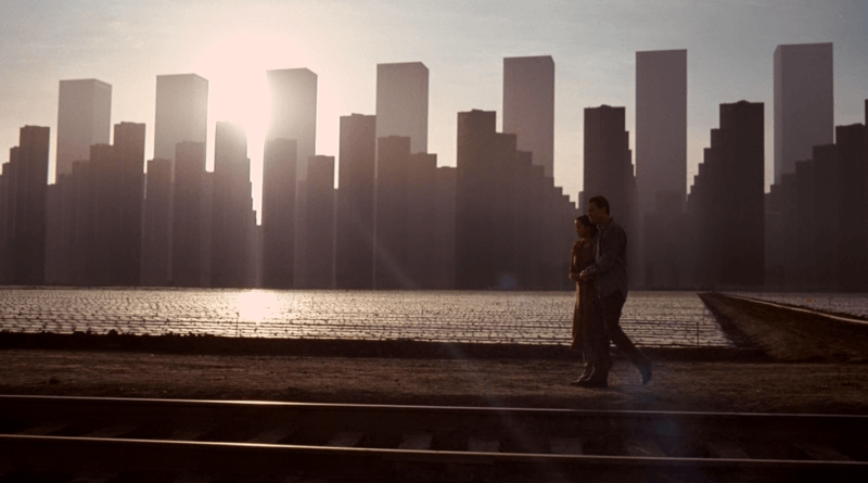 Cobb and Mal walk beside railway tracks beneath the skyline of their dream city in Inception (2010).