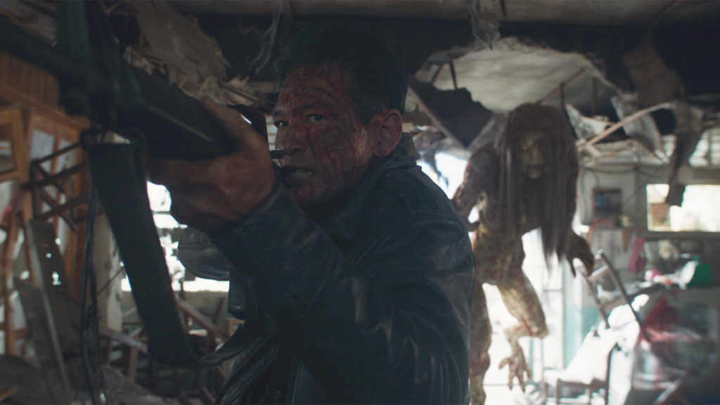 Bum-seok aims a rifle inside a wrecked building while a long-haired alien stands behind him in Hope (2026).